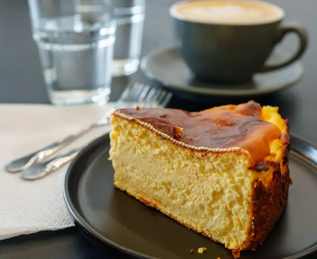 A slice of cheesecake with coffee